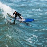 A man is surfing on the waves | Blurb geek