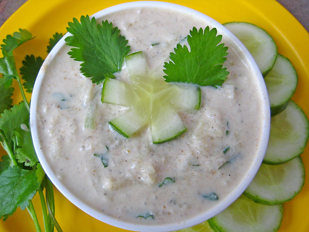 Cucumber-raita-with-cucumber-and-mint-leaves-garnishing