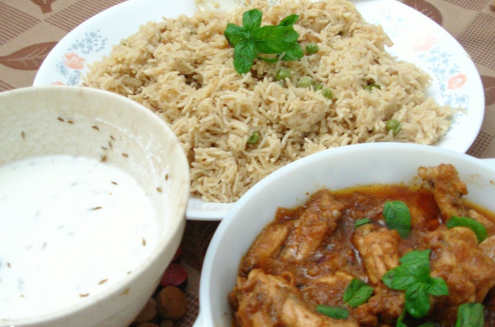 Hyderabadi Chicken Curry and Rice served with yogurt raita