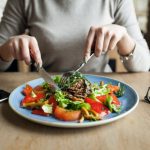 Person Sitting on table having lunch | Blurbgeek