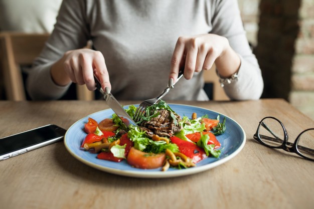 Person Sitting on table having lunch