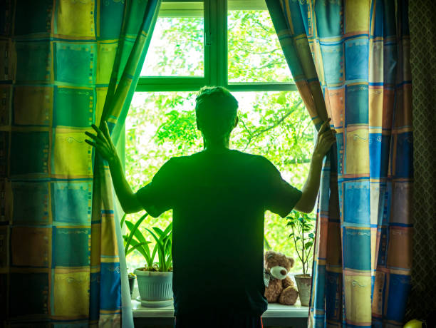 Young man opens curtains on the window on the sunny summer morning - 5 Motivational Things | Blurbgeek